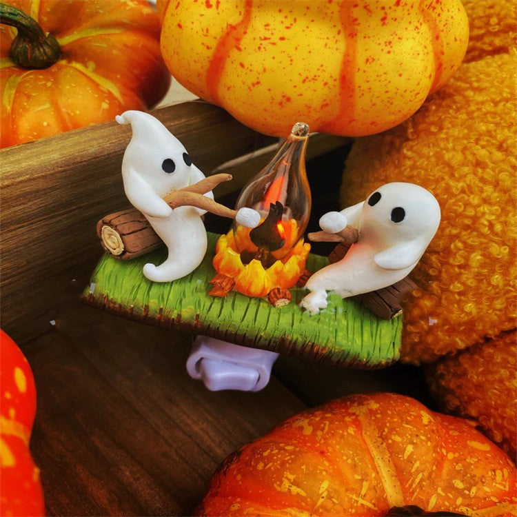 Ghosts around a glowing campfire night light