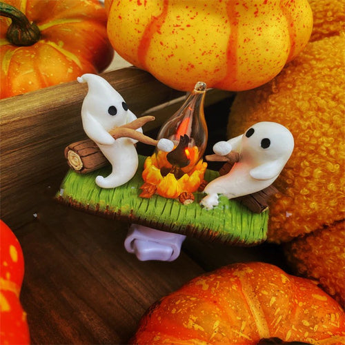 Ghosts around a glowing campfire night light