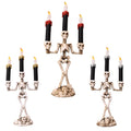 Gold skeleton hand candelabra