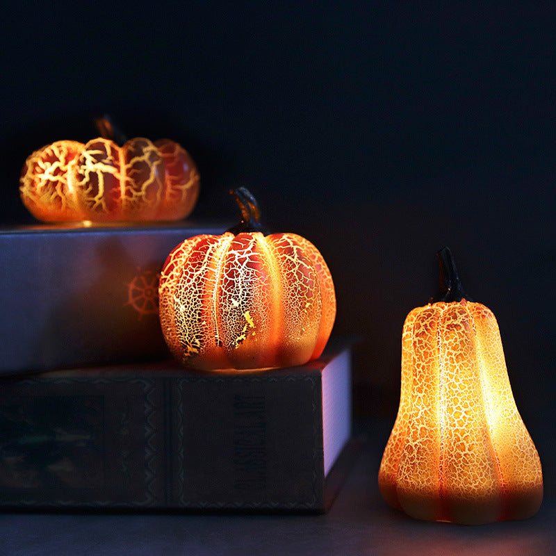 Three LED pumpkin lanterns glowing in the dark