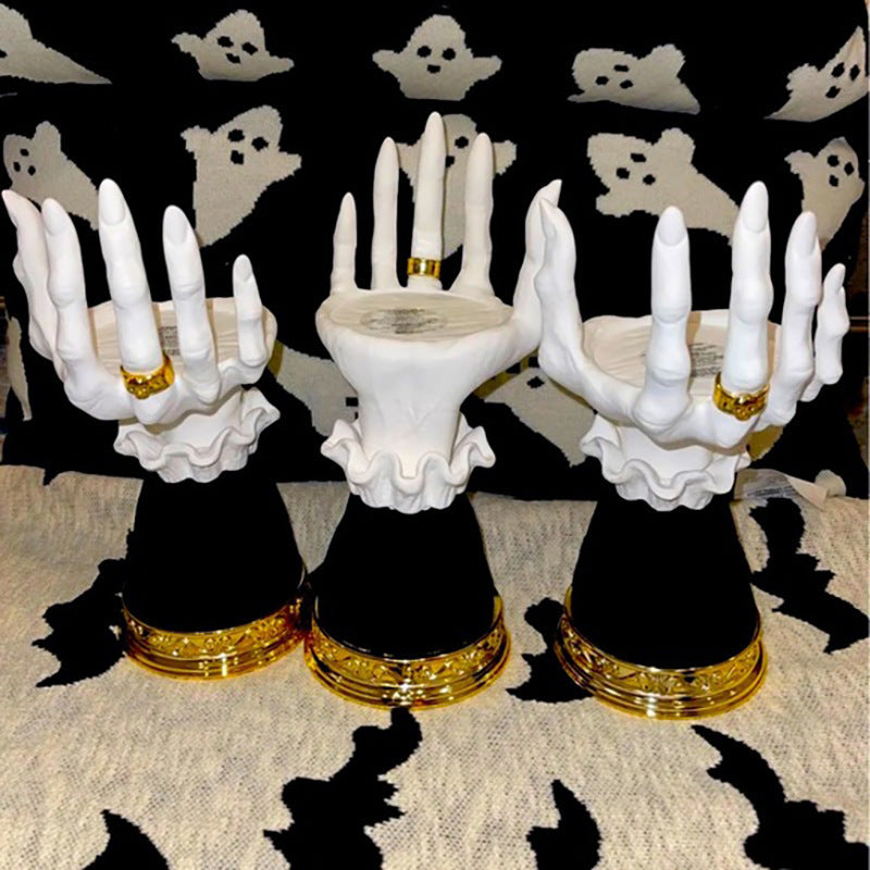 Skeleton hand candle holders on a table