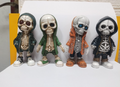 Four skeleton figurines in hoodies, front view