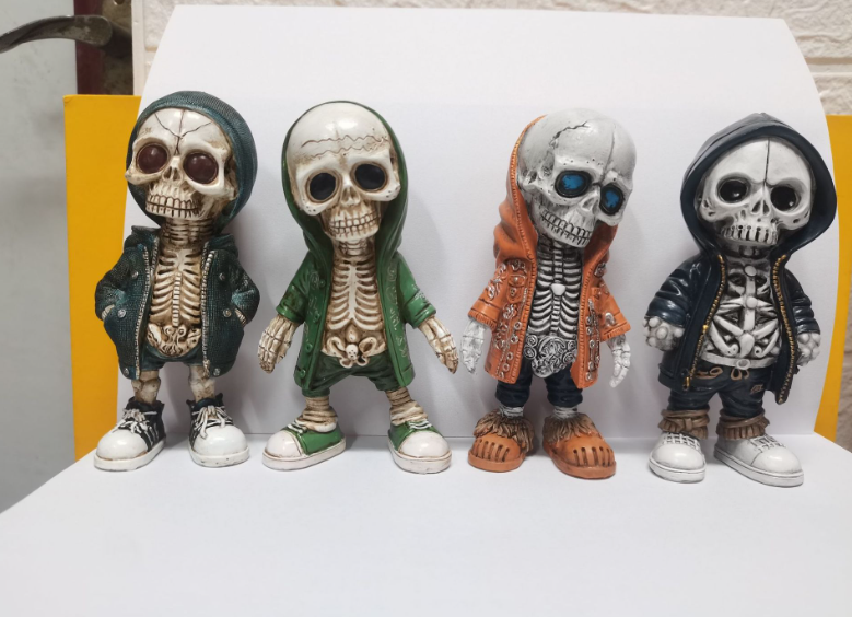 Four skeleton figurines in hoodies, front view